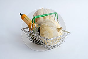 Group of small ornamental pumpkins in shopping basket