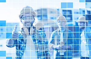 Group of smiling builders in hardhats outdoors