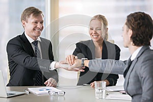 A group of smiling business leaders giving high five