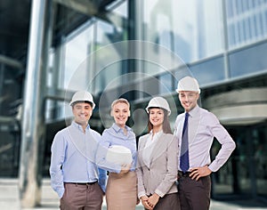 Group of smiling businessmen in white helmets