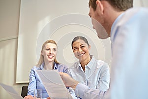 Group of smiling businesspeople meeting in office