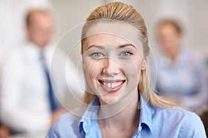 Group of smiling businesspeople meeting in office