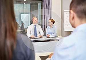 Group of smiling businesspeople meeting in office