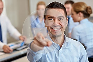 Group of smiling businesspeople meeting in office