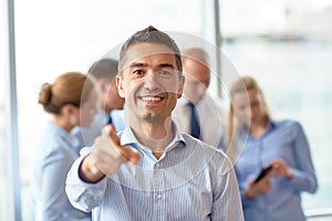 Group of smiling businesspeople meeting in office