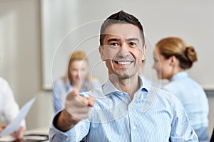 Group of smiling businesspeople meeting in office