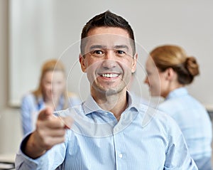 Group of smiling businesspeople meeting in office