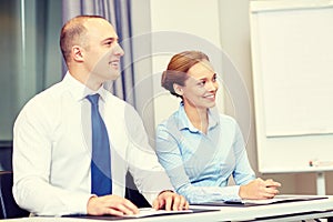 Group of smiling businesspeople meeting in office