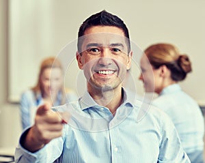 Group of smiling businesspeople meeting in office