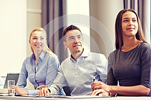 Group of smiling businesspeople meeting in office