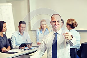 Group of smiling businesspeople meeting in office