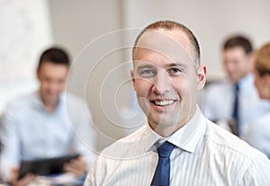 Group of smiling businesspeople meeting in office