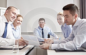 Group of smiling businesspeople meeting in office