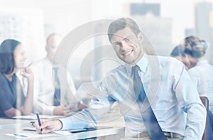 Group of smiling businesspeople meeting in office