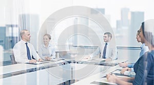 Group of smiling businesspeople meeting in office