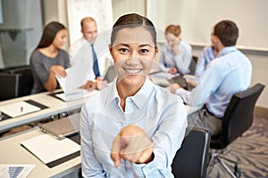 Group of smiling businesspeople meeting in office