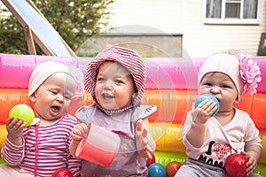 Group of smiling cheerful cute children girls playing together in entertainment park with toys symbolizing children friendship and