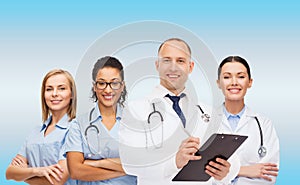 Group of smiling doctors with clipboard