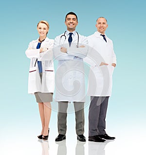 Group of smiling doctors in white coats photo