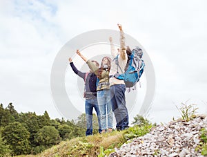 Group of smiling friends with backpacks hiking