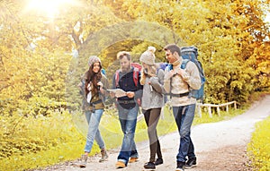 Group of smiling friends with backpacks hiking