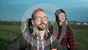 Group of smiling friends enjoying trekking wearing backpack. Medium close up shot on 4k RED camera