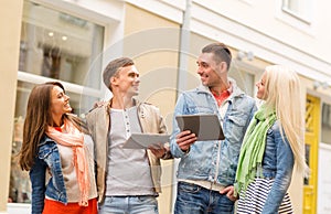 Group of smiling friends with tablet pc computers