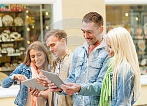 Group of smiling friends with tablet pc computers