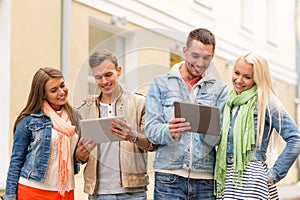 Group of smiling friends with tablet pc computers