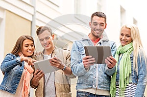 Group of smiling friends with tablet pc computers