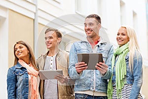 Group of smiling friends with tablet pc computers