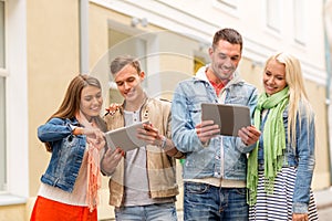 Group of smiling friends with tablet pc computers