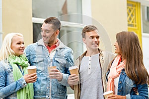 Group of smiling friends with take away coffee