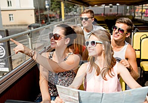 Group of smiling friends traveling by tour bus