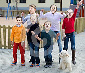 Group of smiling kids in high spirits jumping