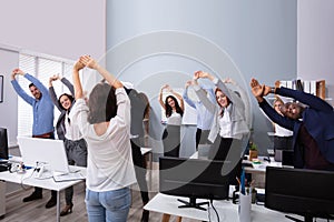 Group Of Smiling Multi-ethnic Businesspeople Doing Exercise