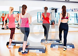 Group of smiling people doing aerobics