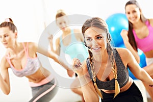 Group of smiling people doing aerobics