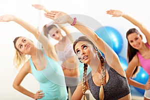 Group of smiling people doing aerobics