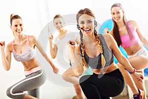 Group of smiling people doing aerobics