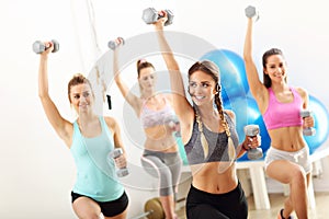 Group of smiling people doing aerobics