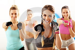 Group of smiling people doing aerobics