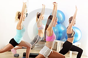 Group of smiling people doing aerobics