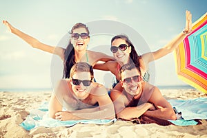 Group of smiling people having fun on the beach