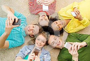 Group of smiling people lying down on floor