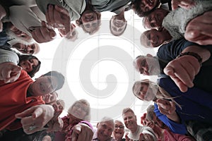 Group of smiling people pointing at the camera
