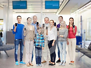 Group of smiling people with smartphones