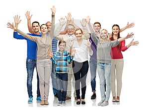 Group of smiling people waving hands