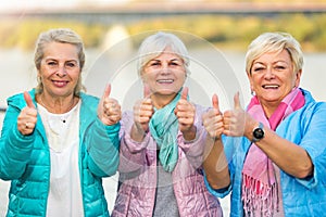 Senior women showing thumbs up photo