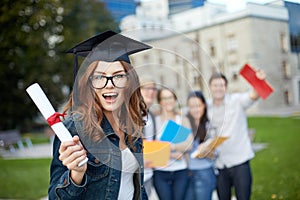 Group of smiling students with diploma and folders